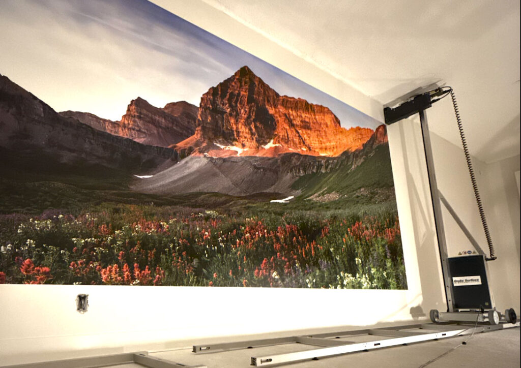 Vertical wall printer applying full-color mural to office wall